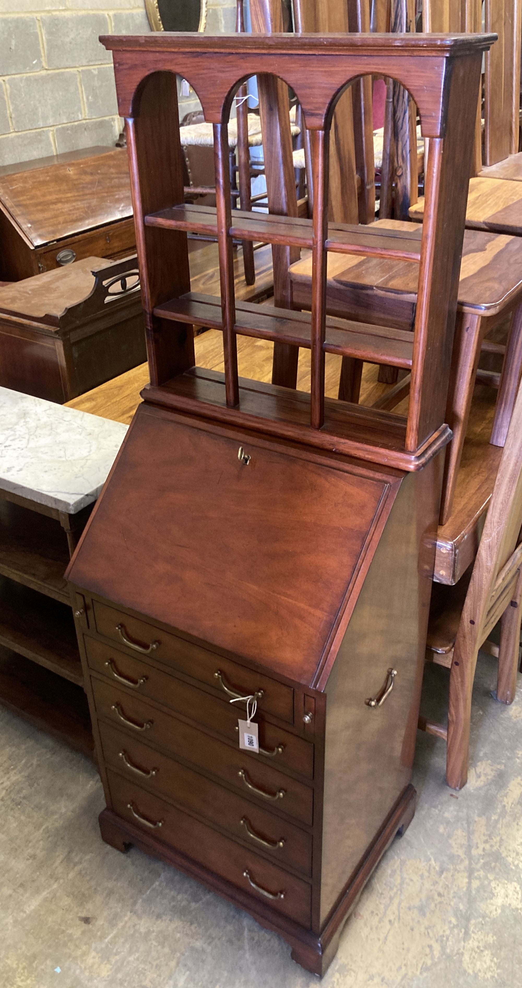 A small reproduction mahogany bureau, width 55cm, depth 43cm, height 102cm together with a three tier wall bracket